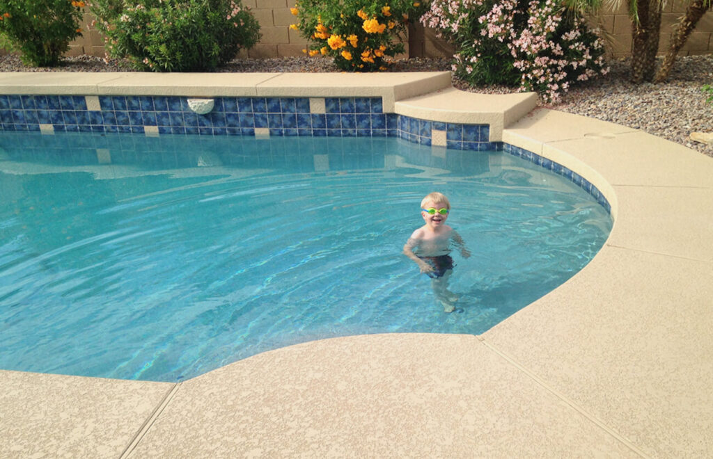 kid in pool with deck